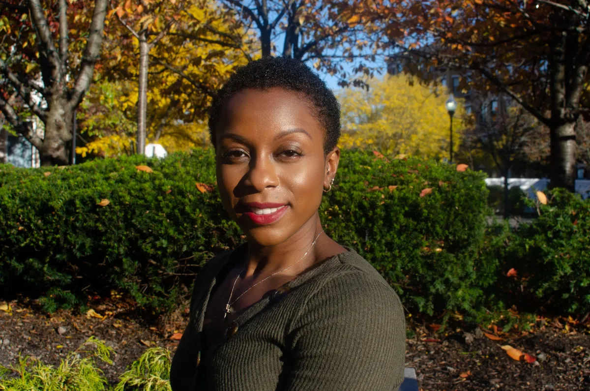 Portrait of a woman with short natural hair among autumn trees